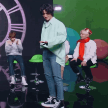 a man in a green shirt is standing in front of two other men