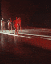 a blurry picture of a person in a dark room with red lights