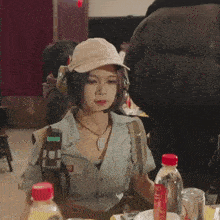 a woman wearing a hat and headphones with the word army on her shirt