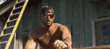 a shirtless man wearing sunglasses and a hat