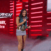 a woman with blue hair is holding a microphone in front of a dash sign