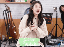 a woman wearing a sweater with the word color switch on it