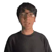 a man wearing glasses and a black shirt that says corey on it