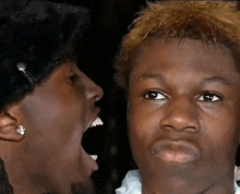 a close up of a person making a funny face with their mouth open