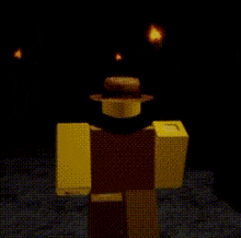 a yellow lego figure is standing in the dark with a hat on .