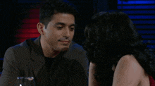 a man and woman are looking into each other 's eyes