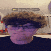 a young man wearing glasses and a black shirt is listening to can you feel my heart