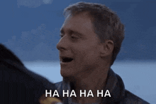 a man is laughing with his mouth open and the words `` ha ha ha ha '' written on the bottom .