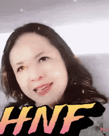 a close up of a woman 's face with the word hnf in the corner