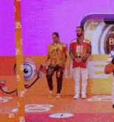 a man wearing a number 01 jersey is standing next to another man on a stage .