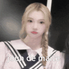 a girl in a sailor suit with the words juun de maite written on the bottom