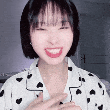 a girl wearing a pajama top with hearts on it