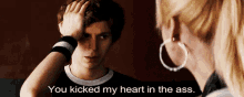 a man holds his hand to his head while a woman says you kicked my heart in the ass