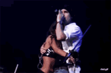 a man and a woman hugging on a stage with a rbd.gif watermark