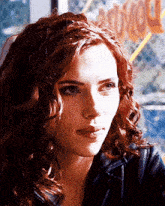 a close up of a woman 's face with a sign in the background that says ' hollywood '