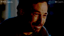 a close up of a man 's face with the words wildcards on the bottom