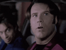 a man with a surprised look on his face is sitting in a car with another man