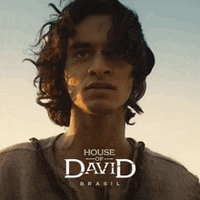 a poster for house of david brasil with a man with long hair