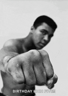 a black and white photo of a man 's fist with the words birthday high five below it