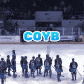 a group of hockey players are standing on the ice with the word coyb above them