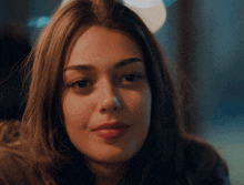 a close up of a woman 's face with a blurry background