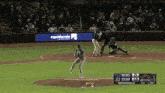 a baseball game is being played with a rapidscale ad in the background
