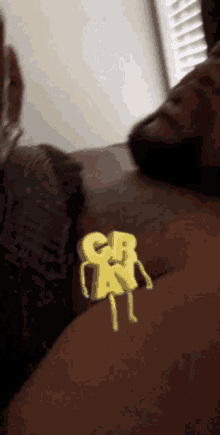 a man is laying on a couch with a cartoon character that says crn
