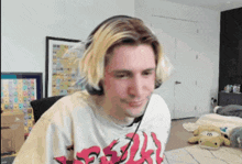 a man wearing headphones and a shirt that says ' evil '