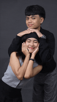 a boy and a girl are posing for a picture and the girl is wearing a headband
