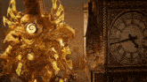 a clock tower with roman numerals and a golden statue