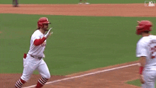 two baseball players are running on a baseball field . one of the players has the number 25 on his jersey .