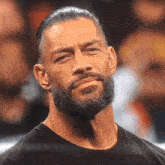 a man with a beard is looking at the camera