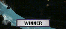 a sign that says `` winner '' is surrounded by a blue splash of water .