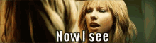 a woman is looking at her reflection in a mirror and saying `` now i see '' .