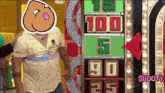 a man with a sticker on his face stands in front of a scoreboard that says $ booty