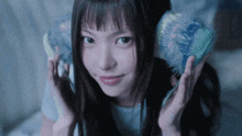 a young woman holds a globe in her hands