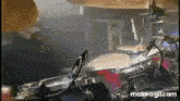 a man is playing drums in a dark room in a band .
