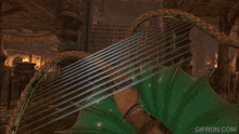 a person is playing a harp with a gifrun.com watermark