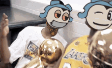 a man in a lakers jersey holds a basketball trophy