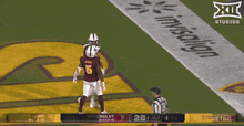 a football game is being played in front of an invisalign sign