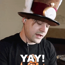 a man wearing a top hat says yay