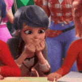 a cartoon girl with blue hair is sitting at a table with her hands on her mouth .