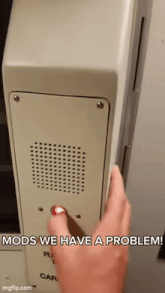 a person pressing a button that says mods we have a problem