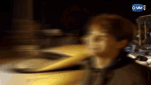 a blurry picture of a man standing next to a yellow car