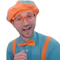 a man in a blue shirt and orange suspenders is wearing an orange beret and glasses