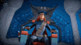 a cartoon character is sitting in a chair in a room with a blue background .