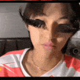 a close up of a person wearing fake eyelashes on their face .