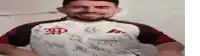 a man with a beard is wearing a white shirt with chinese writing on it