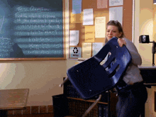 a woman carrying a chair in front of a test question