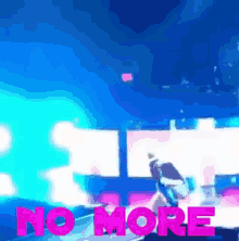 a blurry picture of a stage with the words no more in pink letters